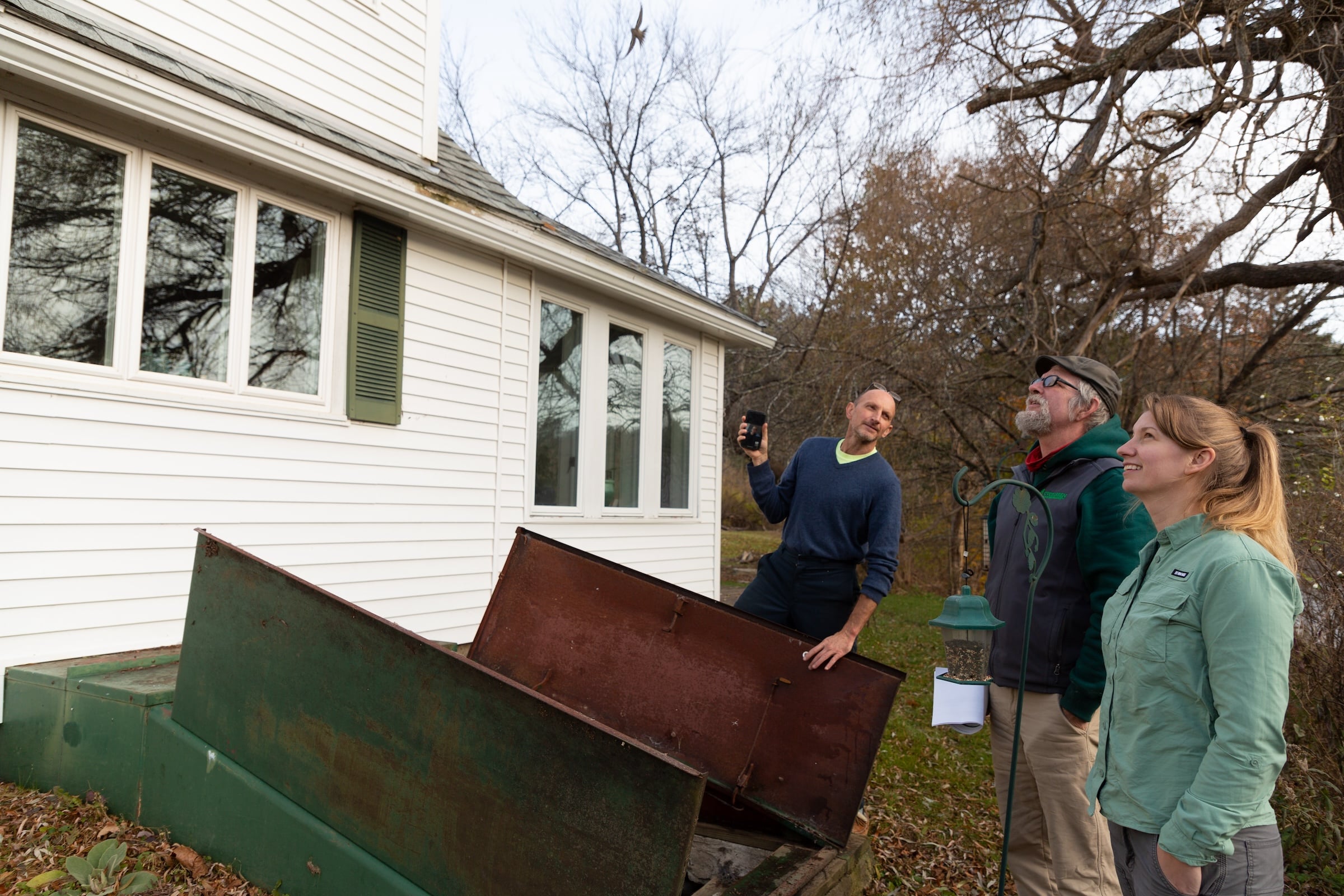 Evergreen team discussing basement inspection with homeowner