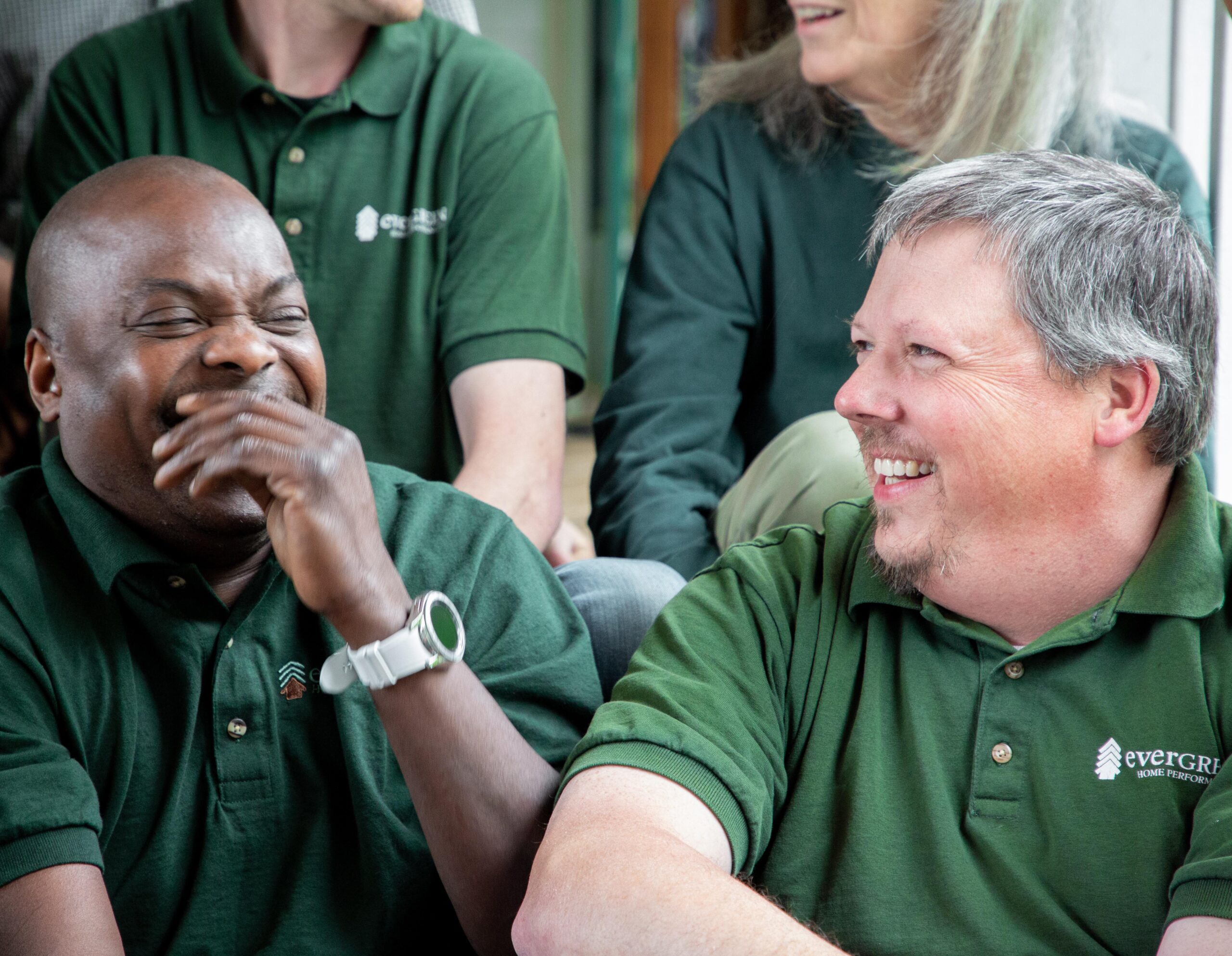 Happy Evergreen employees laughing in conversation