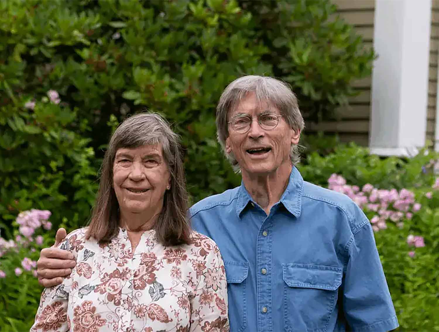 case-study-1 couple standing in front of house