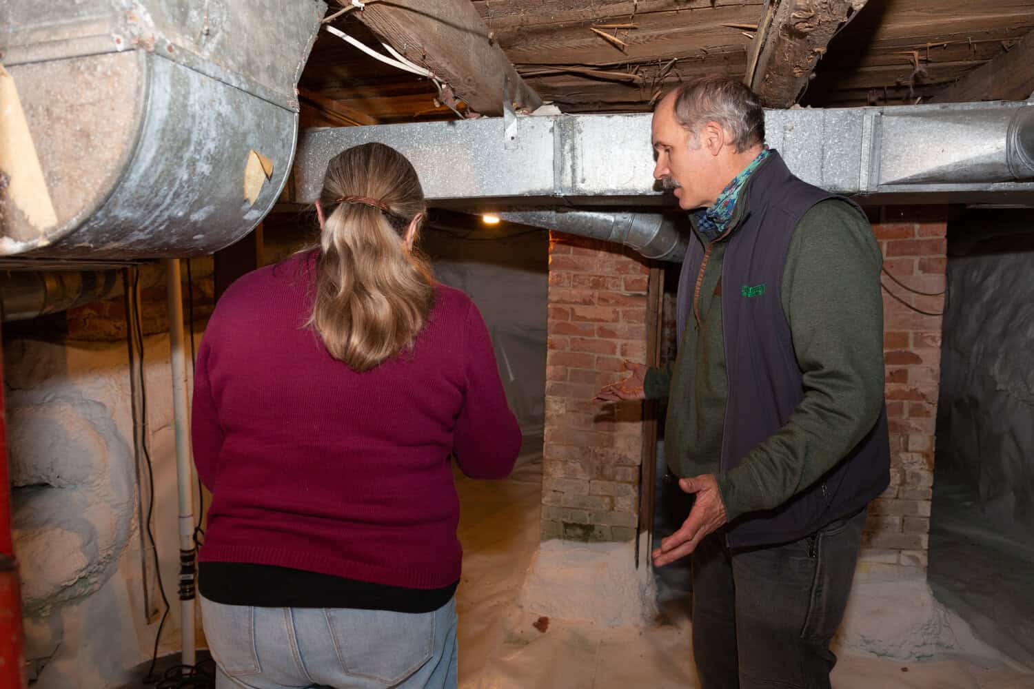 maine-basement-evaluation Evergreen team member evaluating basement with Maine homeowner