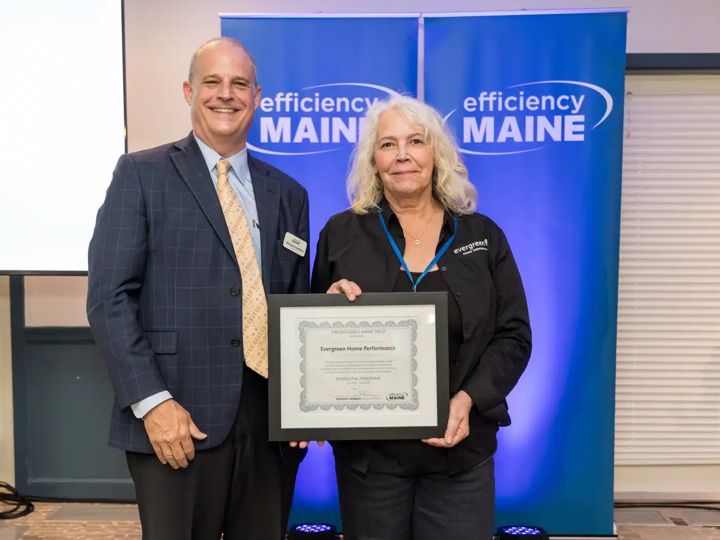 Efficiency Maine Executive Director Michael Stoddard presents the 2026 recognition certificate to Evergreen Home Performance.