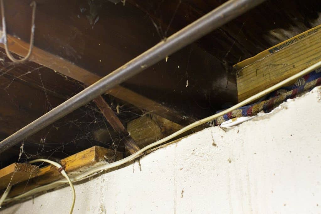 Basement rim joist before air sealing and insulation Gap at the basement rim joist before air sealing and insulation